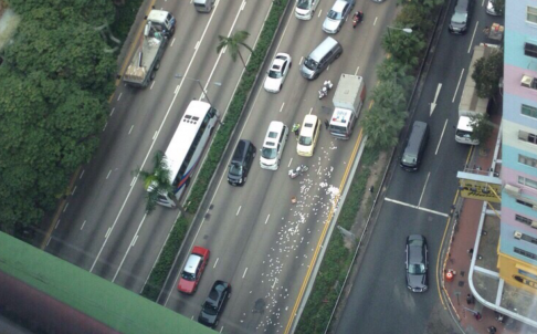 Cash is strewn over Gloucester Road in Wan Chai. Photo: SCMP