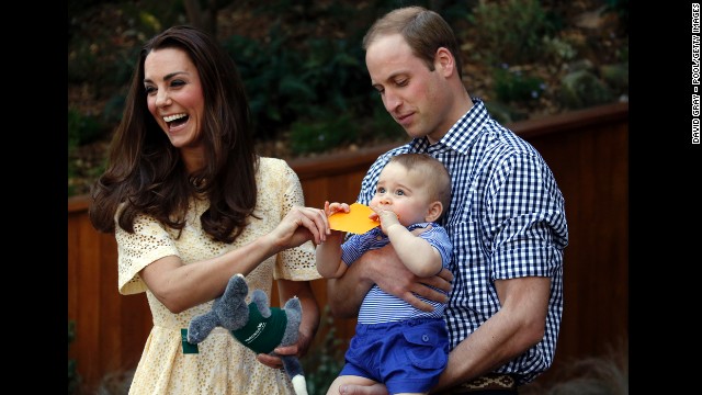 Catherine and William react as their son bites a small present at the bilby enclosure of Sydneys Taronga Zoo on April 20. One of the zoos bilbies was renamed George in honor of the young prince.