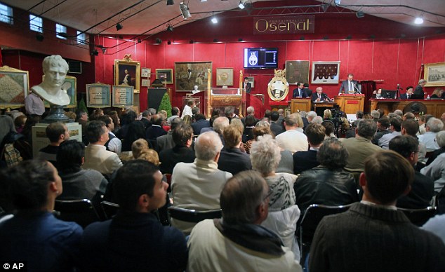 Sold! The hat was bought for £1.5million at a packed auction at Fontainebleau, near Paris, today (above)