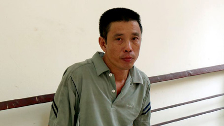 Trần Quang Huy tại trụ sở công an.