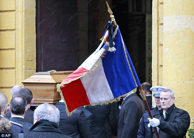 Defender: The coffin of Franck Brinsolaro, the police officer charged with protecting late Charlie Hebdo editor Stephane Charbonnier, is carried out of the Sainte-Croix Church during his funeral