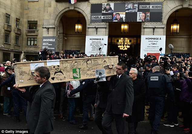 Paying tribute: The coffin of Bernard Verlhac kown as Tignous, is carried outside the town hall of Montreuil after the tribute service today