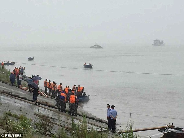 Emergency services and rescue patrol the river in a bid to find survivors amid the stormy weather conditions