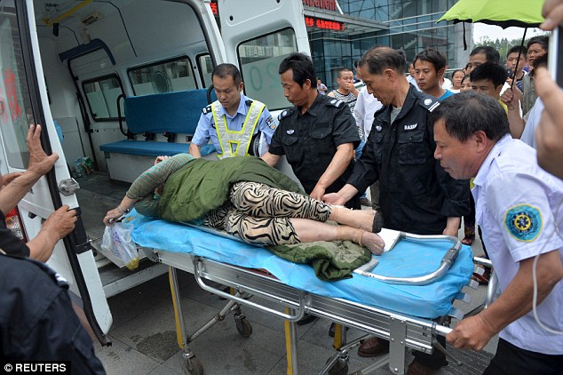 A survivor is loaded into the back of an ambulance after she was rescued from inside the ship