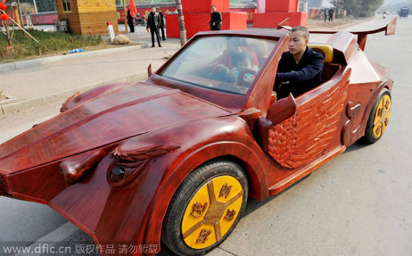 Chinese farmer Yu Jietao drives his homemade wooden sports car with his family on a road in Guangfeng county, Shangrao city, East Chinas Jiangxi province, February 9, 2015.