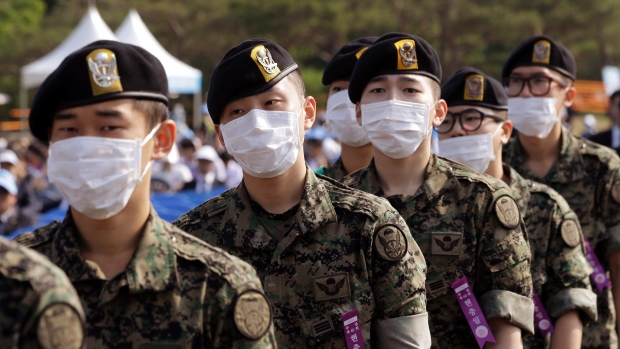 South Korean soldiers wear masks as a precaution against MERS virus on their arrival for a ceremony to mark South Koreas 60th Memorial Day at the National Cemetery in Seoul, South Korea.