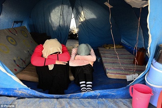 The girls were routinely stripped naked before being categorized and shipped off. Above, Yazidi women who managed to escape from ISIS earlier this year