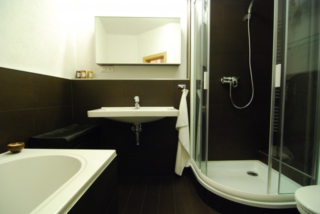 Phòng tắm của căn hộ có diện tích vừa phải với hai tông màu trắng đen lịch lãm. Các vật dụng được cất giấu trong tủ gương nhờ vậy, phòng tắm luôn gọn gàng, ngăn nắp