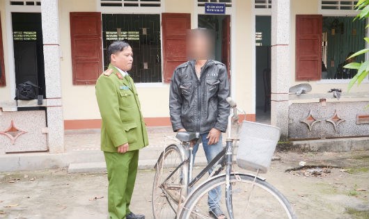
Trung tá Dương Chí Hòa bàn giao chiếc xe đạp cho bố cháu Khoa
