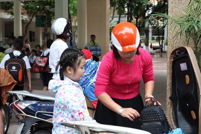 S&aacute;ng sớm nay, kh&ocirc;ng kh&iacute; lạnh tr&agrave;n về k&egrave;m theo mưa nhỏ khiến nền nhiệt giảm s&acirc;u. Trong ảnh, c&aacute;c em nhỏ được bố mẹ chuẩn bị kỹ lưỡng trước khi đến trường.