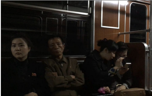 
Hai cô gái chăm chú vào màn hình di động trên tàu điện ngầm Bình Nhưỡng. Ảnh:SCMP
