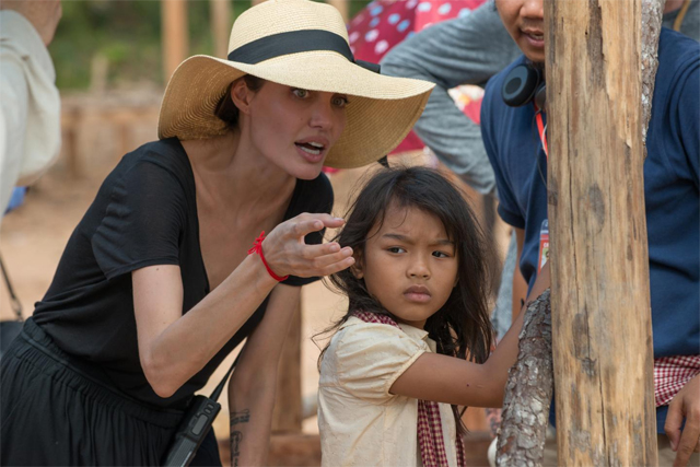 
Jolie hướng dẫn bé Srey Moch trong một cảnh quay.
