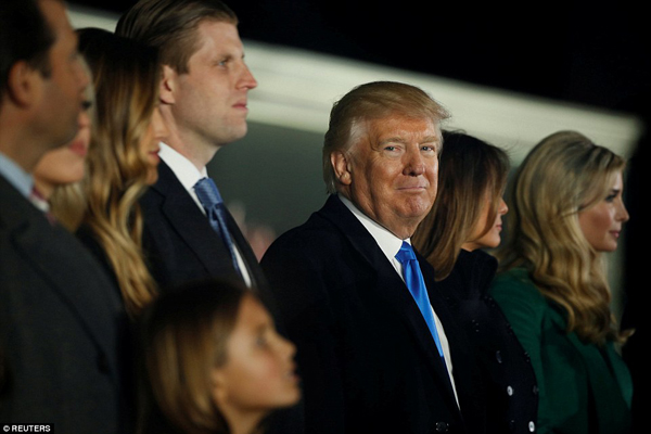 
Trump mỉm cười khi đứng giữa vợ và các con, cháu.
