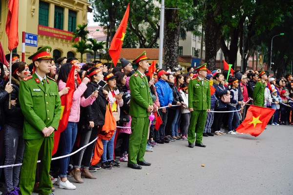 
Phố Hoàng Văn Thụ, quận Ba Đình, gần với Văn phòng Chính phủ, cổ động viên đứng kín trên vỉa hè, cảnh sát giao thông lập thành hàng rào để xe của đội tuyển sẽ đi qua trong vài chục phút nữa. Ảnh: VNE
