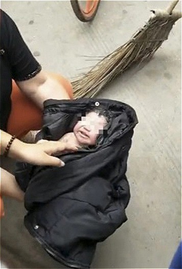 Bé sơ sinh sau khi được tìm thấy trong thùng rác. Ảnh: SCMP.