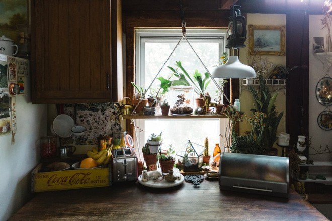 Kệ hai ngăn gắn ở khung cửa sổ phía trước bàn làm việc mang đến nét duyên dáng và xanh tươi cho không gian.