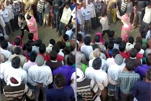 Người phụ nữ bị chồng đánh bằng roi da trước mặt nhiều người đàn ông trong làng.