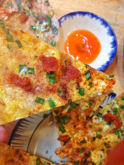 V&igrave; mang phong c&aacute;ch ẩm thực Đ&agrave; Lạt n&ecirc;n thực đơn qu&aacute;n c&ograve;n c&oacute; m&oacute;n b&aacute;nh tr&aacute;ng nướng - linh hồn của những khu chợ đ&ecirc;m Đ&agrave; Lạt. B&aacute;nh tr&aacute;ng nướng với trứng, mỡ h&agrave;nh v&agrave; thịt b&ograve; kh&ocirc;, chấm với tương ớt.