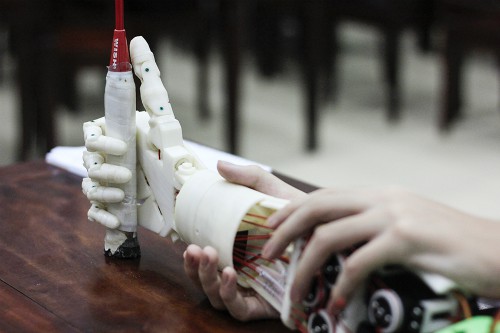 
Với sự điều khiển bằng suy nghĩ, cánh tay robot của Huy và Khôi đã có thể cầm nắm các vật nhỏ. Ảnh: Dương Tâm
