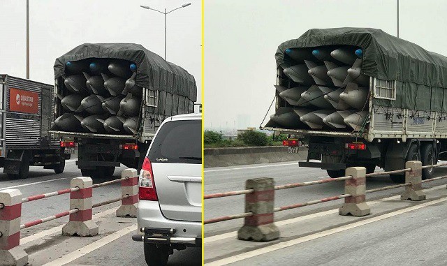 
Chiếc xe tải mang BKS 99C – 059.61 chở nhiều bình nhiên liệu nghi của máy bay đi trên cầu Thanh Trì, Hà Nội. Ảnh: PV
