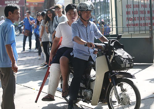 Hoàng Giang (THCS Ngô Sĩ Liên) bị dập dây chằng, phải bó bột, được người thân đưa đến trường dự thi. Ảnh: Ngọc Thành.