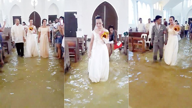 Cô dâu Jobel Delos Angeles mặc váy cưới lội nước trong nhà thờ thuộc thị trấn Hagonoy, Philippines, hôm 11/8. Ảnh chụp từ video.