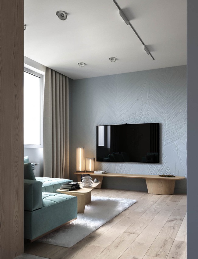 Đối diện với sofa xanh chính là bức tường đá khổng lồ với họa tiết lá được chạm khắc tinh tế.