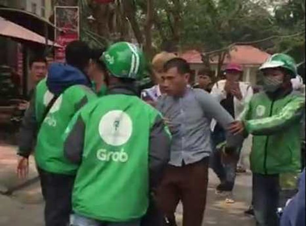 Nguyễn Văn Tâm (áo kẻ) bị lực lượng chức năng bắt giữ.