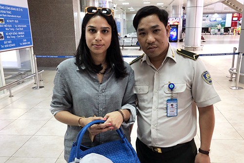 Nữ du khách nhận tài sản khi để quên ở sân bay quốc tế Cam Ranh, hôm 14/3. Ảnh: Trung Thanh.