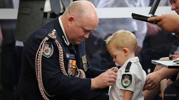 Xót xa cảnh bé trai 19 tháng tuổi nhận huân chương thay cha hy sinh trong cháy rừng - Ảnh 1.