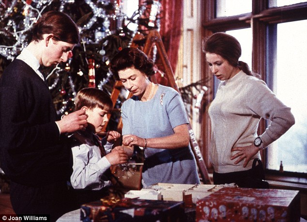 Family Christmas: The Queen helps Andrew open a present watched by Charles and Anne. But look at the size of the tree!