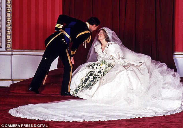 Dress of dreams: Prince Charles manages to avoid the 25ft train as he asks for a kiss from his bride