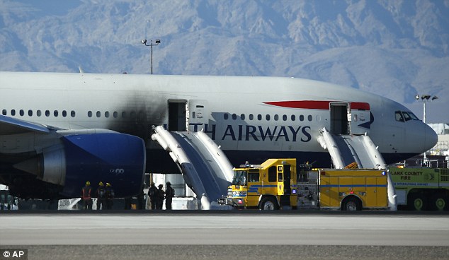 One side of the plane was damaged in the fire. The evacuation slides are still deployed as firefighters investigate the area in the aftermath of the blaze 