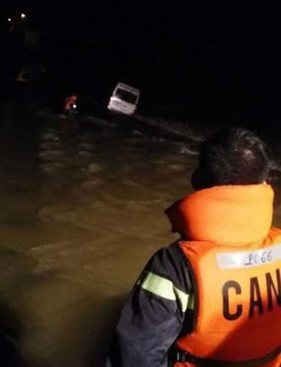 Công an huyện Khánh Vĩnh, Khánh Hòa tiếp cận xe bị nước cuốn trôi. Ảnh: Đ.N