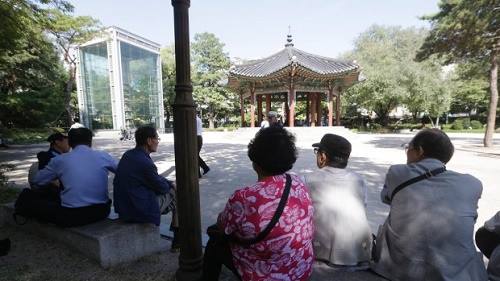 [Caption] photo, elderly people sit in the shade at Tapgol park in Seoul, South Korea. The park, mostly a place for relaxation for elderly residents in Seoul, had also been a site where elderly prostitutes solicit customers for sex in nearby motels. After widespread police crackdown this spring, many elderly prostitutes have disappeared in Seoul but some still operate near a plaza in front of the Piccadilly theater, which is about 10 minutes walk from Tapgol Park. (Ahn Young-joon, Associated
