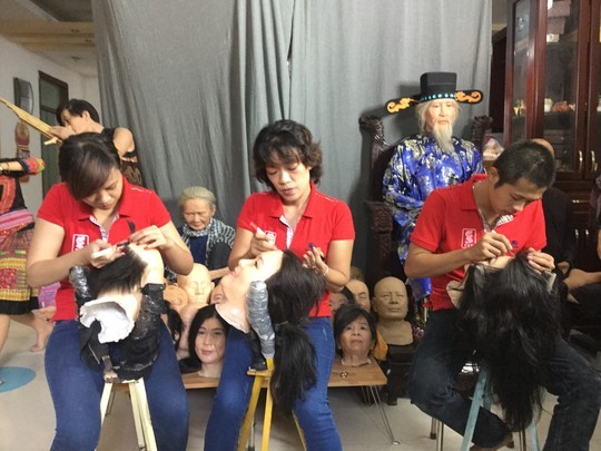 Các chuyên viên gắn tóc lên khuôn mặt các bức tượng nghệ sĩ.