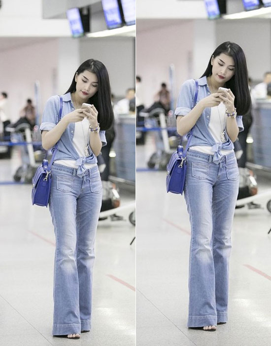 Người mẫu Lan Hương chọn quần jeans ống loe cho thời trang tại sân bay.