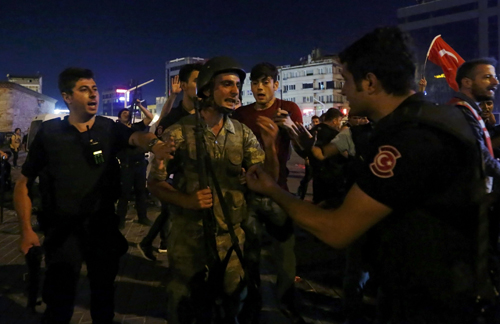 Người dân chất vấn các binh sĩ thực hiện vụ đảo chính. Ảnh: Reuters