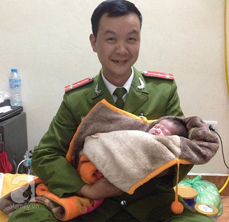
Thượng úy Hoàng đang ôm ấp đứa bé trong sự yêu thương và chia sẻ với PV về cảm giác khi nhặt được em ở gốc cây.
