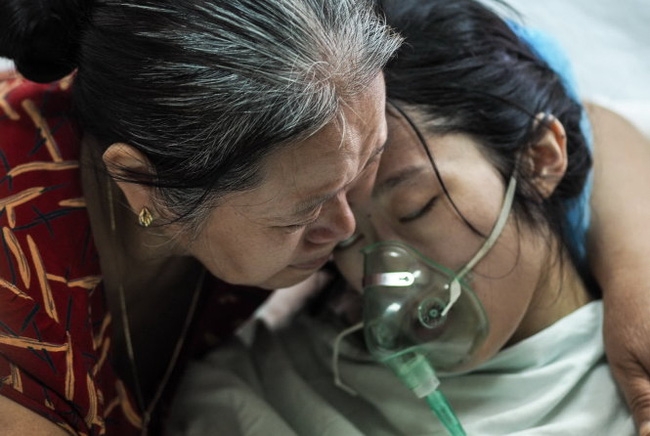 Chị Đậu Thị Huyền Trâm trong vòng tay mẹ trong những ngày được điều trị tại Bệnh viện K, ảnh chụp sáng 26-7 trước khi chị Trâm về quê nhà Hà Tĩnh trong buổi chiều cùng ngày - Ảnh: Tuổi Trẻ