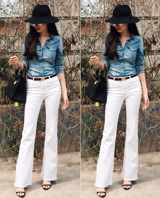 Thủy Anh gây ấn tượng với style cá tính trong chiếc áo sơ mi denim, quần ống loe màu trắng. Túi xách, mũ rộng vành, sandal được bà xã Đăng Khôi phối khá đồng điệu.