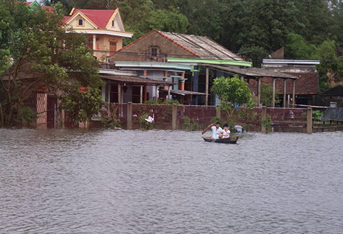 Nước ngập ngang nhà, người dân di chuyển bằng thuyền ở Quảng Bình. Ảnh: Táo Hoàng.