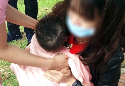 B&eacute; trai được mọi người cho&agrave;ng &aacute;o kho&aacute;c sau khi được cứu l&ecirc;n bờ. Ảnh: Minh Mọi
