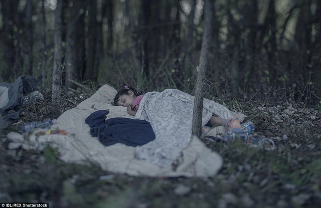 Lamar, 5, originally from Baghdad, sleeps on a blanket in the woods near Horgos, Serbia. She and her family were on their way to buy food when a bomb was dropped close to their house. Forced out of their home, after two attempts to cross the sea from Turkey in a small, rubber boat, they succeeded in reaching Hungarys closed border