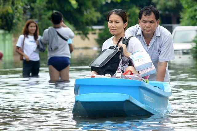 
Người dân ở Bangkok phải dùng thuyền di chuyển do ngập lớn khiến ôtô cũng không thể chạy.
