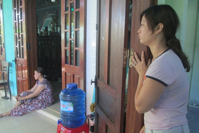 Chị Nguyễn Thị Hương, mẹ em H (ngồi) và chị Văn Thị Huệ (đứng tựa vào cửa) bàng hoàng trước cái chết của các con. Ảnh: Lê Chung