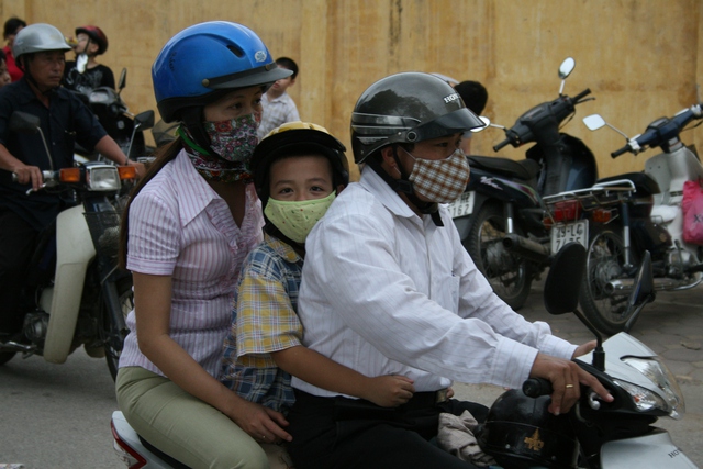 Người dân khi ra đường nên bịt khẩu trang, đeo kính, mặc quần áo dài tay để bảo vệ sức khỏe. Ảnh: Chí Cường