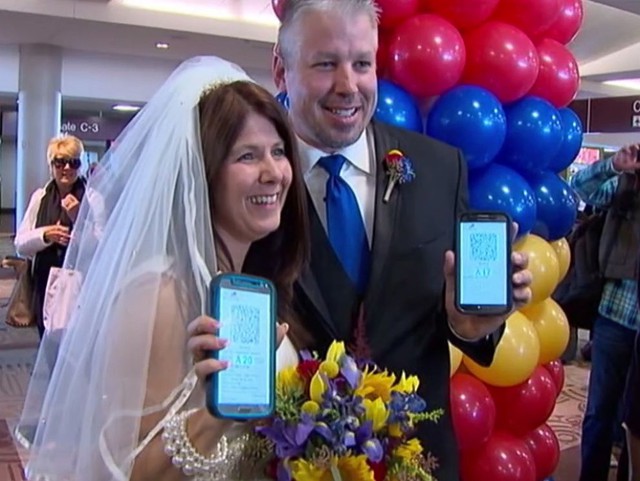 Dottie Coven and Keith Stewart read vows from their mobile phones.