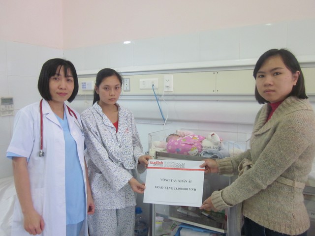 Bà Dương Minh Thu - Đại diện Quỹ Vòng tay nhân ái (Báo GĐ&XH) trao tiền ủng hộ cho đại diện Khoa Sơ Sinh điều trị cho bé