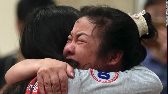 Two women comfort each other on Tuesday, June 2, at a Nanjing, China, hotel, where relatives of passengers trapped in the capsized cruise ship have gathered.